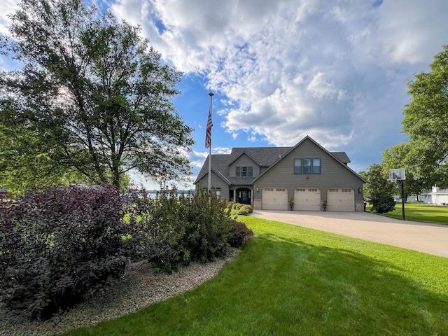 view of front of house with a garage, concrete driveway, and a front lawn