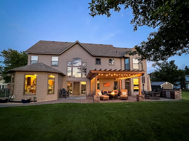 back of house at dusk with a patio area, an outdoor kitchen, an outdoor living space, and a pergola