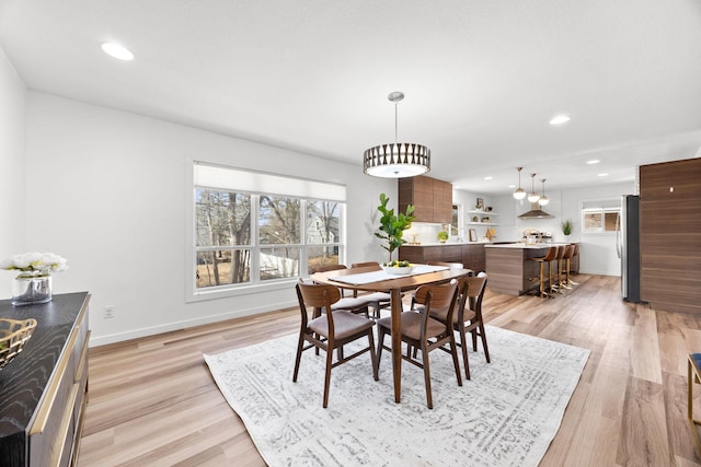 dining space featuring light wood finished floors, recessed lighting, and baseboards