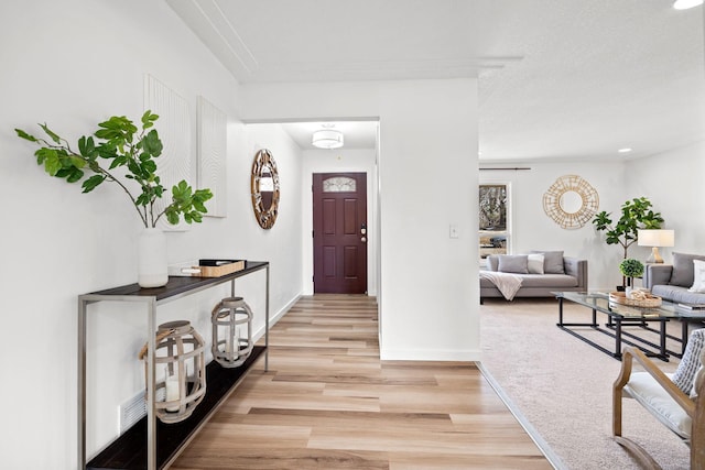 entrance foyer featuring baseboards and light wood-style floors