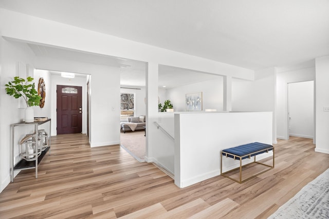 foyer entrance featuring baseboards and light wood-type flooring