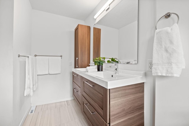 bathroom with visible vents, vanity, and baseboards