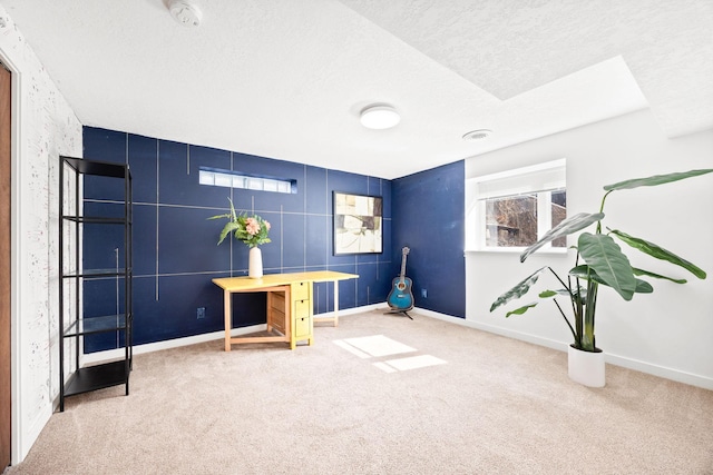 sitting room with baseboards, a textured ceiling, and carpet flooring