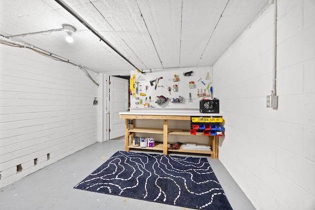 interior space featuring a workshop area and finished concrete flooring