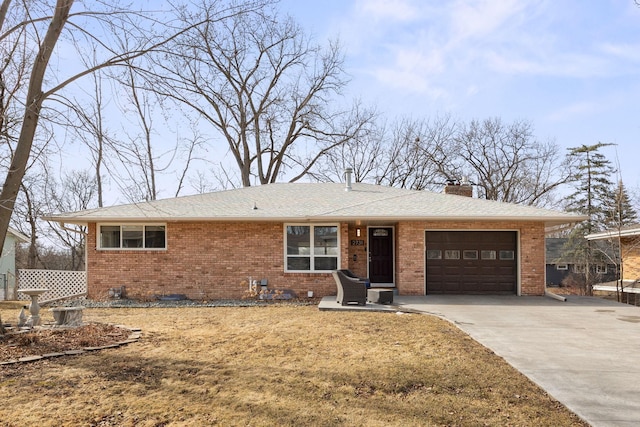 single story home with a chimney, concrete driveway, a garage, crawl space, and brick siding