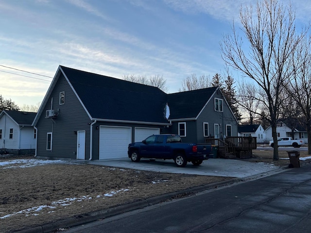 view of front of property with driveway, a garage, a residential view, and a deck