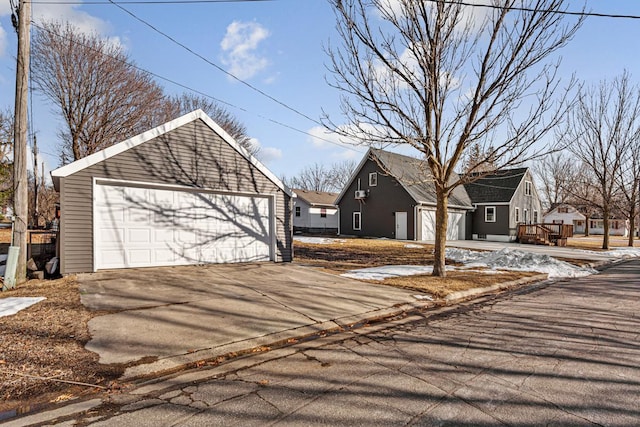 exterior space with an outbuilding and a detached garage