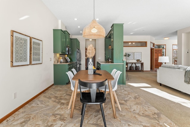 dining space with recessed lighting, light carpet, and baseboards