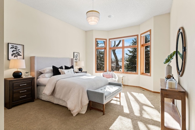 bedroom with a textured ceiling, baseboards, and light colored carpet