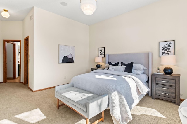 bedroom featuring visible vents, baseboards, and light colored carpet