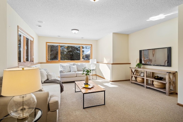 living area with carpet floors, a textured ceiling, and baseboards