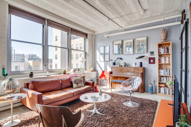 living area with a view of city and baseboard heating