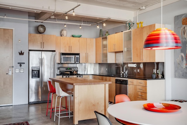 225 9th St E Unit 504, Saint Paul, MN 55101 - kitchen with appliances with stainless steel finishes, wood counters, concrete flooring, and light brown cabinets