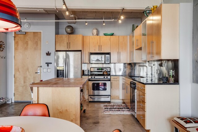 225 9th St E Unit 504, Saint Paul, MN 55101 - kitchen featuring appliances with stainless steel finishes, a sink, rail lighting, light brown cabinets, and a kitchen island