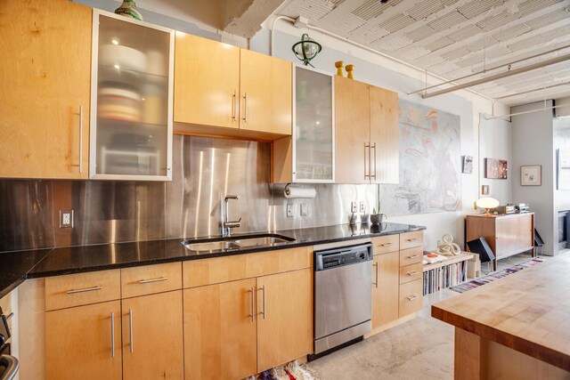 225 9th St E Unit 504, Saint Paul, MN 55101 - kitchen featuring stainless steel dishwasher, a sink, dark stone countertops, and glass insert cabinets
