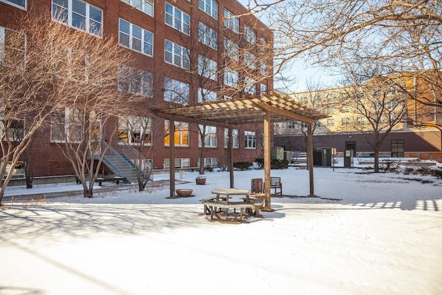 225 9th St E Unit 504, Saint Paul, MN 55101 - yard layered in snow with a pergola