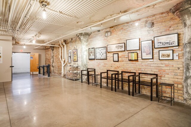 225 9th St E Unit 504, Saint Paul, MN 55101 - miscellaneous room featuring concrete floors and brick wall