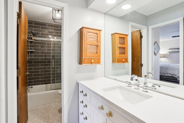 bathroom with connected bathroom, toilet, bathing tub / shower combination, vanity, and tile patterned floors