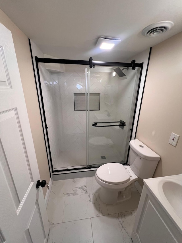 bathroom featuring toilet, marble finish floor, visible vents, and a stall shower