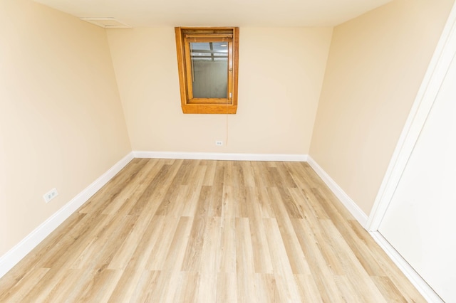 spare room featuring light wood-style flooring and baseboards