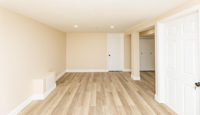 spare room featuring baseboards, recessed lighting, and light wood-style floors