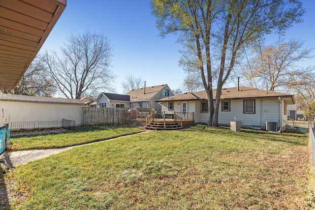 exterior space with fence, a deck, and central AC unit