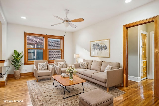 living area with a ceiling fan, recessed lighting, light wood-style flooring, and baseboards