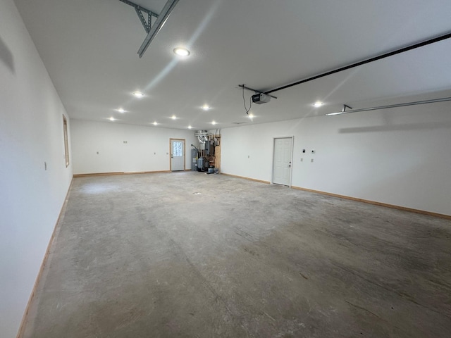 garage featuring a garage door opener and baseboards