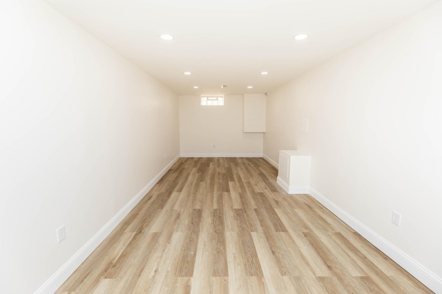 empty room with recessed lighting, baseboards, and light wood finished floors