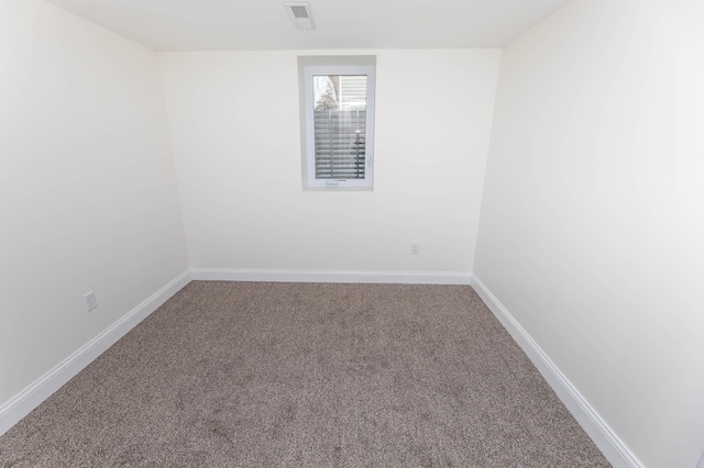 spare room with baseboards, visible vents, and carpet floors