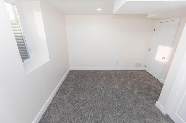 empty room featuring visible vents, recessed lighting, carpet, and baseboards