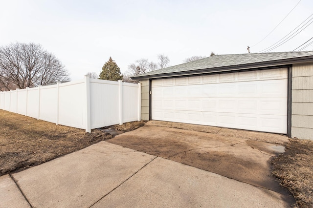 detached garage featuring fence