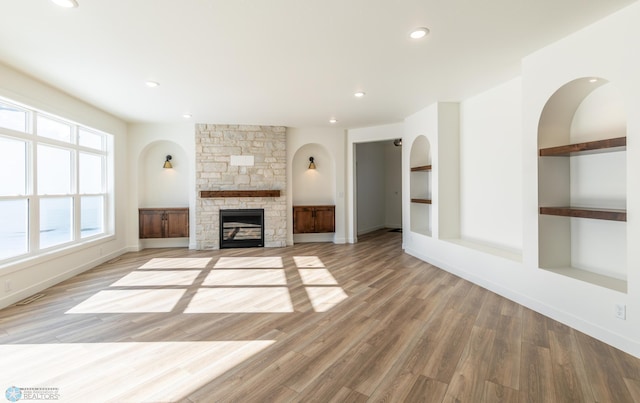 unfurnished living room featuring a fireplace, light wood-type flooring, recessed lighting, and baseboards