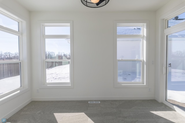 unfurnished sunroom featuring plenty of natural light