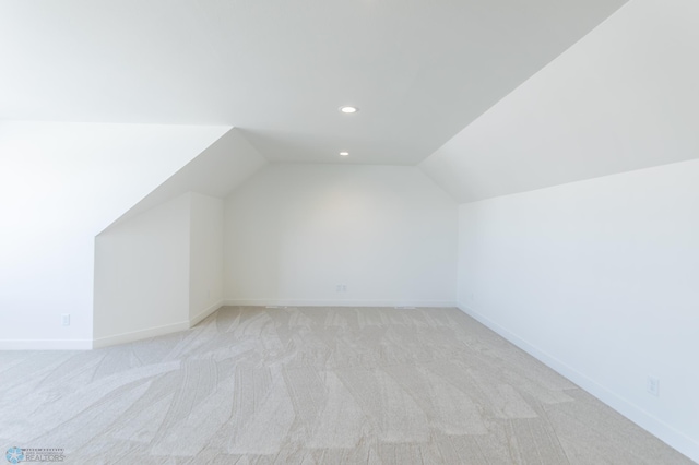 additional living space featuring vaulted ceiling, light carpet, recessed lighting, and baseboards