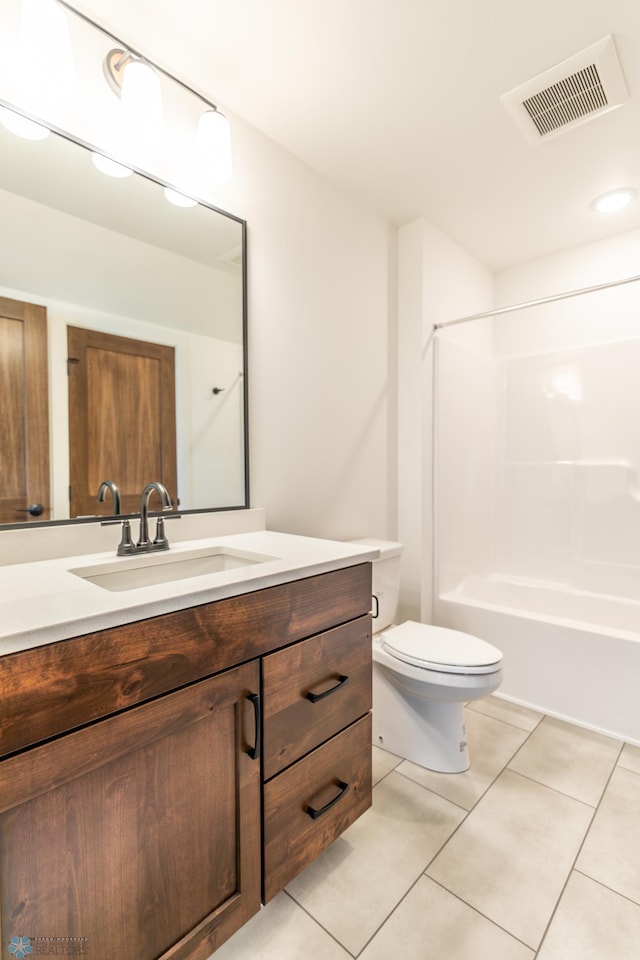 full bath featuring toilet, tile patterned floors, vanity, and tub / shower combination