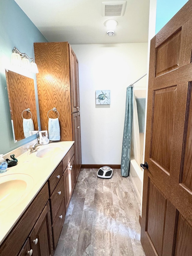 full bath featuring shower / bath combination with curtain, visible vents, a sink, and double vanity