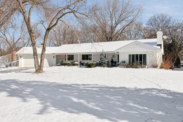 view of front of home featuring a garage and a chimney