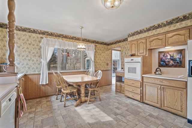 2905 Lake Blvd N, Saint Paul, MN 55109 - kitchen featuring white appliances, wallpapered walls, light stone finish floors, a wainscoted wall, and light countertops