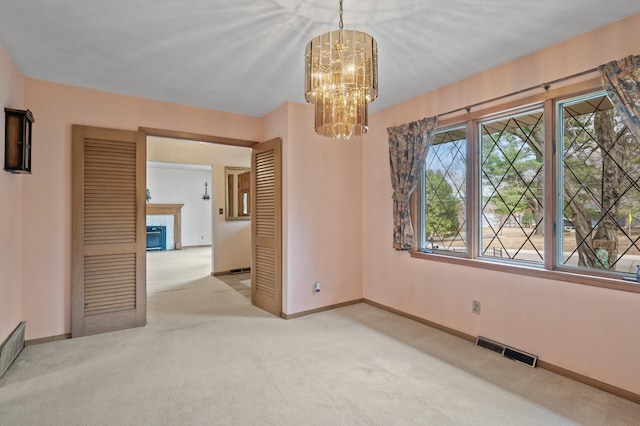2905 Lake Blvd N, Saint Paul, MN 55109 - unfurnished dining area with carpet flooring, a chandelier, baseboards, and a glass covered fireplace