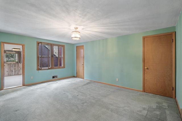2905 Lake Blvd N, Saint Paul, MN 55109 - unfurnished room with carpet floors, baseboards, and a chandelier