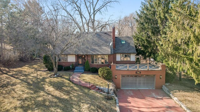 2905 Lake Blvd N, Saint Paul, MN 55109 - tudor home with concrete driveway, brick siding, a garage, and a front yard