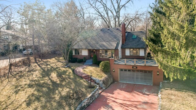 2905 Lake Blvd N, Saint Paul, MN 55109 - english style home featuring driveway, brick siding, a garage, a chimney, and roof with shingles