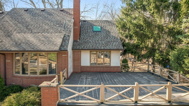 2905 Lake Blvd N, Saint Paul, MN 55109 - rear view of property featuring roof with shingles, a chimney, brick siding, and a deck