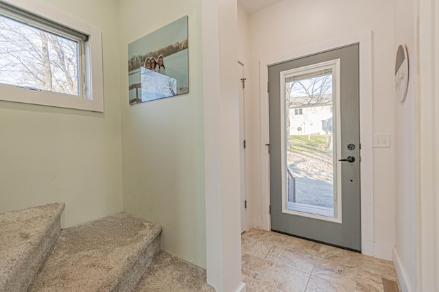 entryway with a healthy amount of sunlight and stairway