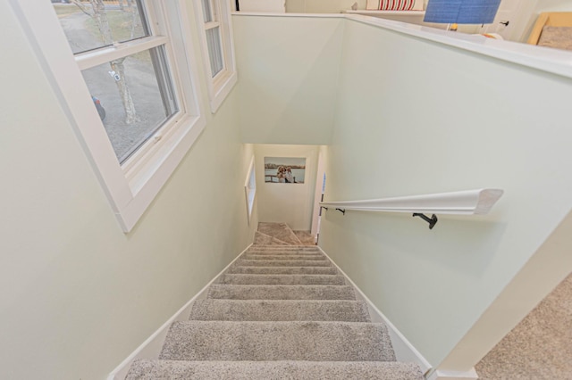 stairs featuring carpet and baseboards