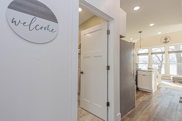 hall with wood finished floors and recessed lighting