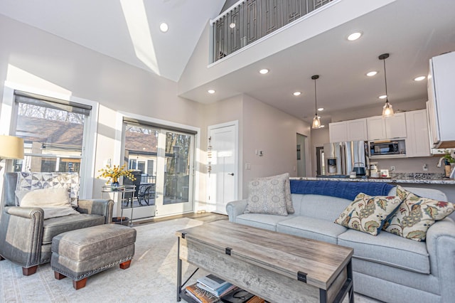 living area with plenty of natural light, high vaulted ceiling, and recessed lighting