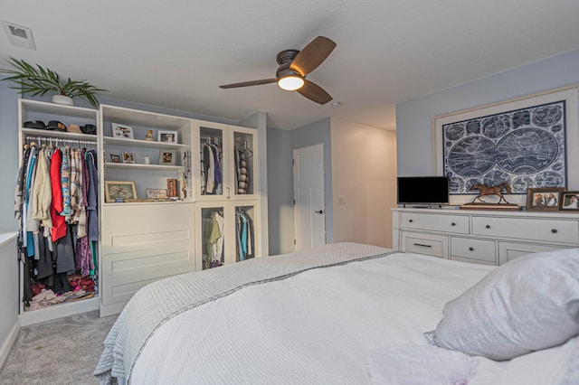 bedroom with light carpet, baseboards, visible vents, a ceiling fan, and a closet