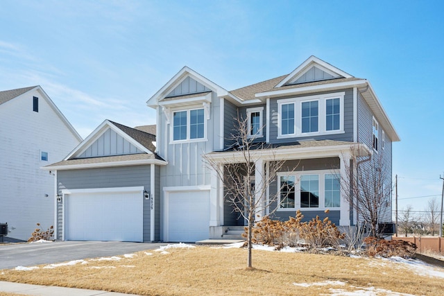 view of front of house with driveway, central AC, a shingled roof, a garage, and board and batten siding